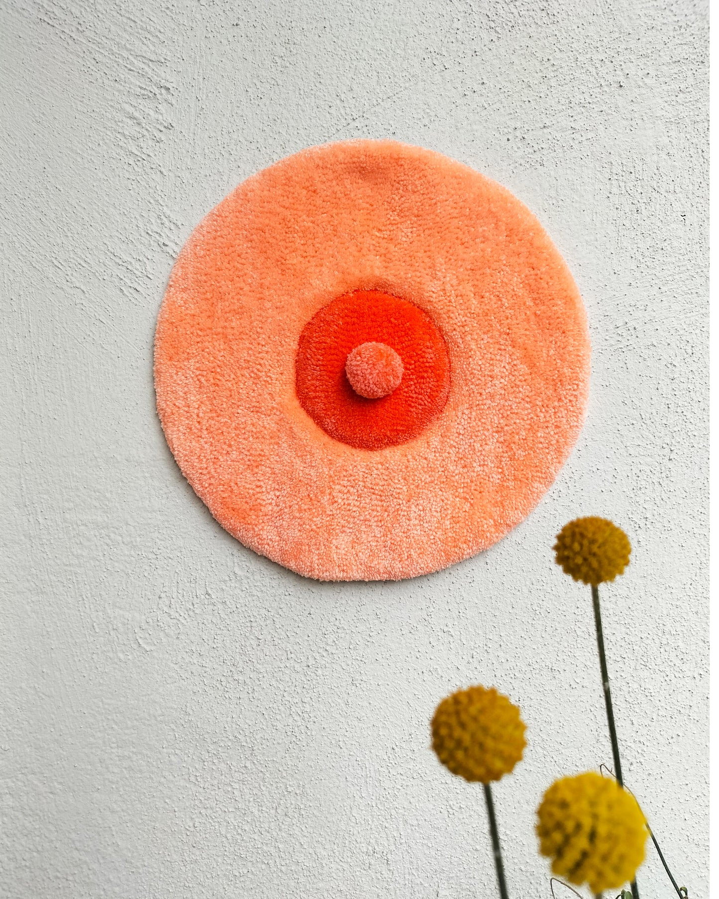 Handmade tufted boobie wall hanging in peach and red tones, feminist body-positive art decor for modern interiors